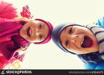 childhood, leisure, friendship, autumn and people concept - happy boy and girl faces outdoors