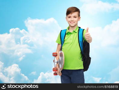 childhood, leisure, gesture, school and people concept - happy smiling student boy with backpack and skateboard showing thumbs up over blue sky and clouds background