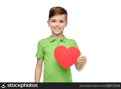 childhood, love, charity, health care and people concept - happy smiling boy in green polo t-shirt holding blank red heart shape