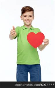 childhood, love, charity, health care and people concept - happy smiling boy in green polo t-shirt holding blank red heart shape and showing thumbs up