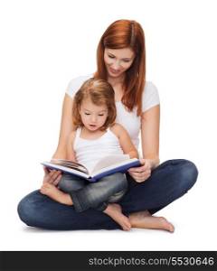 childhood, parenting and relationship concept - happy mother with adorable little girl reading book