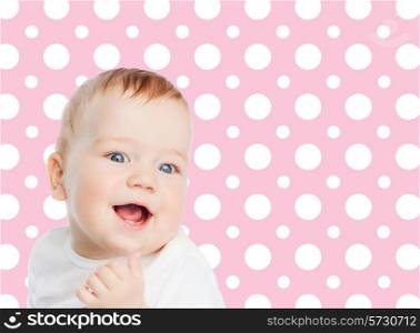 childhood, people and happiness concept - smiling baby girl face over pink and white polka dots pattern background
