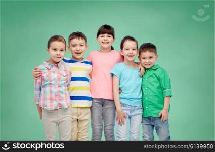 childhood, preschool education, friendship and people concept - group of happy smiling little children hugging over green school chalk board background