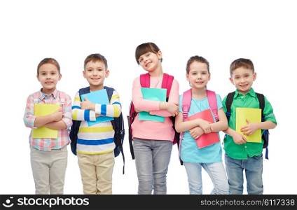 childhood, preschool education, learning and people concept - group of happy smiling little children with school bags and notebooks