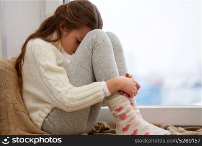 childhood, sadness and people concept - beautiful sad girl at home. beautiful sad girl at home