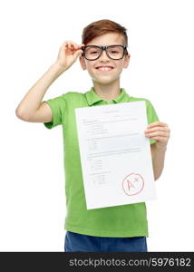 childhood, school, education and people concept - happy smiling boy in eyeglasses holding paper with test result