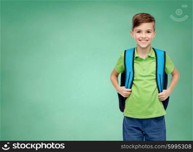 childhood, school, education and people concept - happy smiling student boy with school bag over green school chalk board background