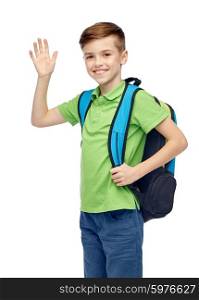 childhood, school, education, greeting gesture and people concept - happy smiling student boy with school bag waving hand