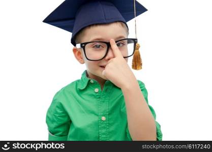 childhood, school, education, knowledge and people concept - happy boy in bachelor hat or mortarboard and eyeglasses