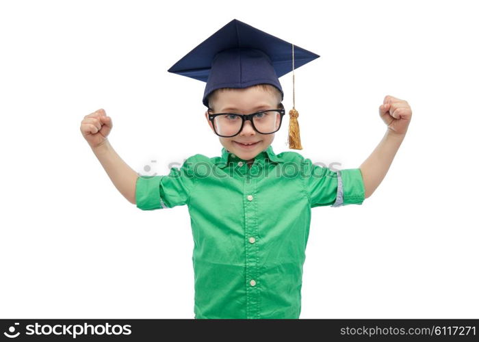 childhood, school, education, knowledge and people concept - happy boy in bachelor hat or mortarboard and eyeglasses showing strong hands