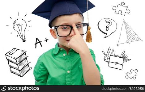 childhood, school, education, knowledge and people concept - happy boy in bachelor hat or mortarboard and eyeglasses over doodles