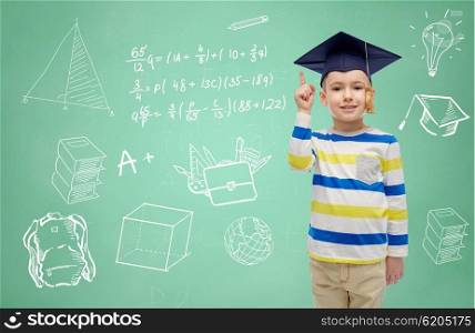 childhood, school, education, knowledge and people concept - happy boy in bachelor hat or mortarboard and eyeglasses over doodles on green chalk board background