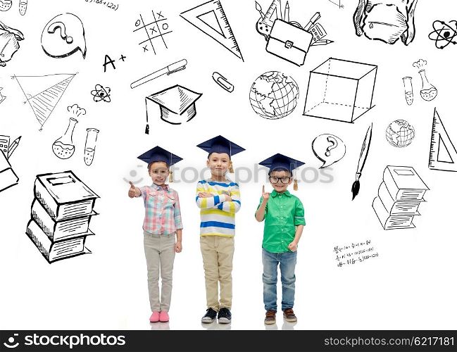 childhood, school, education, knowledge and people concept - happy children in bachelor hats or mortarboards and eyeglasses over doodles