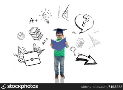 childhood, school, education, learning and people concept - happy boy in bachelor hat or mortarboard and eyeglasses reading book with doodles