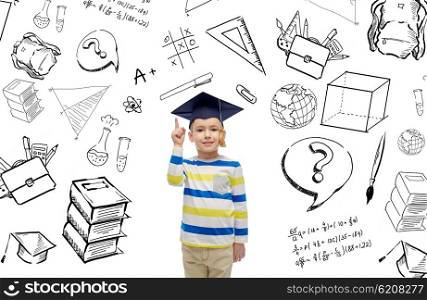 childhood, school, education, learning and people concept - happy boy in bachelor hat or mortarboard pointing finger up with doodles