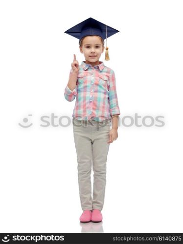 childhood, school, education, learning and people concept - happy girl with in bachelor hat or mortarboard