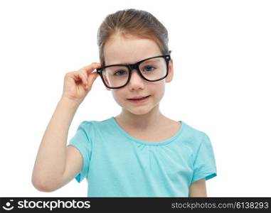 childhood, school, education, vision and people concept - happy little girl in eyeglasses