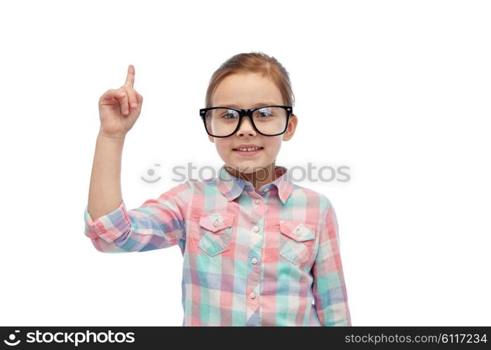 childhood, school, education, vision and people concept - happy little girl in eyeglasses pointing finger up