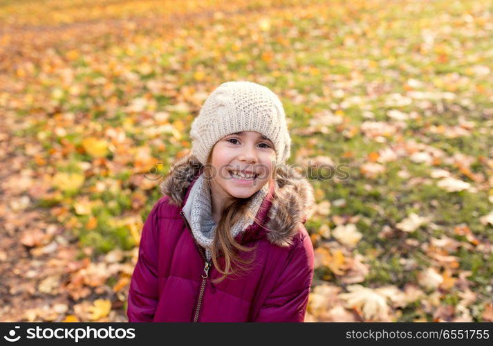 childhood, season and people concept - happy beautiful little girl at autumn park. happy beautiful little girl at autumn park. happy beautiful little girl at autumn park