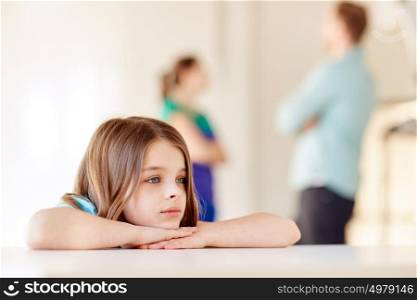 childhood, social issue, sadness and people concept - beautiful sad girl and parents arguing at home. beautiful sad girl and parents arguing at home