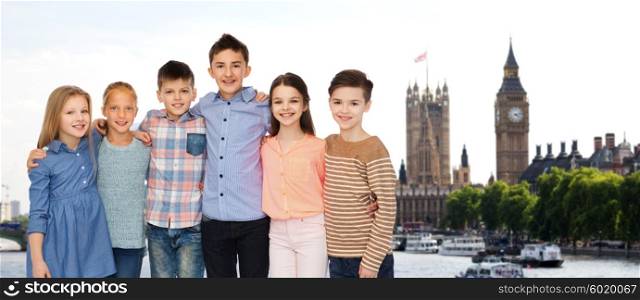 childhood, travel, tourism, friendship and people concept - happy smiling children hugging over london city background