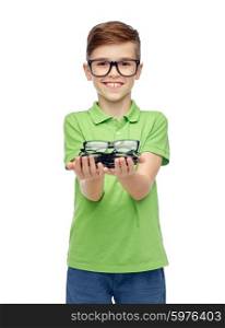 childhood, vision, eyesight, health care and people concept - happy smiling boy in green polo t-shirt with eyeglasses