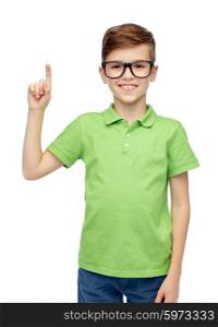 childhood, vision, school, education and people concept - happy smiling boy in green polo t-shirt in eyeglasses pointing finger up