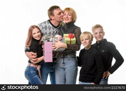 Children and dad congratulated mom on her birthday by giving her gifts, dad kisses mom a. Children and dad congratulated mom on her birthday by giving her gifts, dad kisses mom