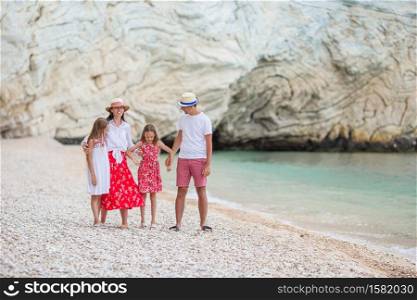 Children and parents on the beach have fun. Young family on vacation have a lot of fun