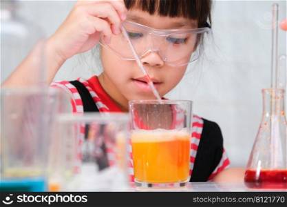 Children are learning and doing science experiments in the classroom. Little girl playing science experiment for home schooling. Easy and fun science experiments for kids at home.