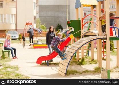 Children are playing at the playground outdoors