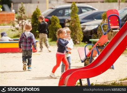 Children are playing at the playground outdoors