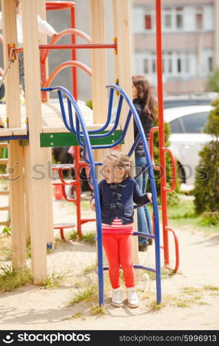 Children are playing at the playground outdoors. Children at the playground