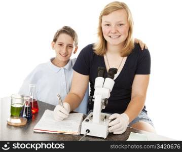 Children at school, doing science experiments and examining results under microscope. White background.