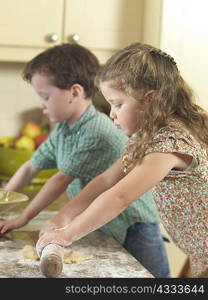 Children baking together in kitchen