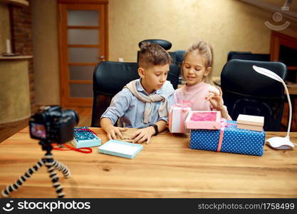 Children bloggers poses on camera, little bloggers. Kids blogging in home studio, social media for young audience, online internet broadcast. Children bloggers poses on camera, little bloggers