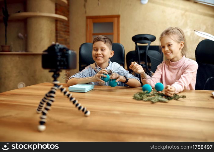 Children bloggers shooting on camera for blog. Kids blogging in home studio, social media for young audience, online broadcast. Children bloggers shooting on camera for blog