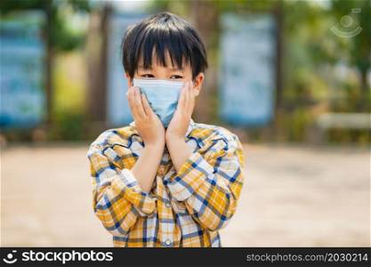 children boy wearing a mask to prevent dust and viruses