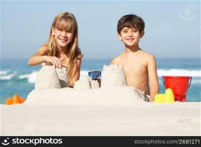 Children Building Sandcastles On Beach Holiday