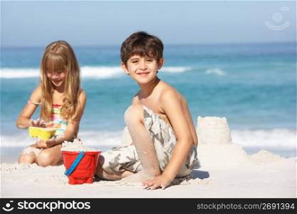 Children Building Sandcastles On Beach Holiday
