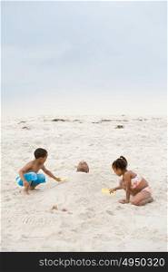 Children burying father in sand