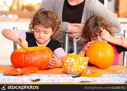 Children carving halloween pumpkins