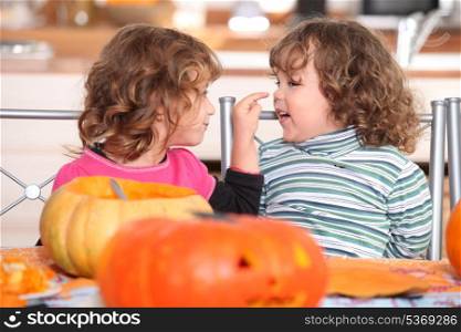 Children carving Halloween pumpkins