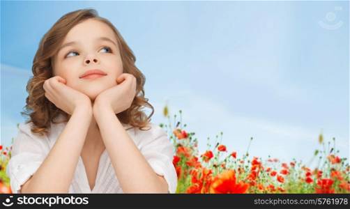 children, childhood, nature, summer and happy people concept - beautiful girl looking up and dreaming over poppy field background
