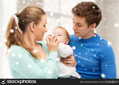 children, christmas, x-mas, love concept - happy family and adorable baby with feeding-bottle