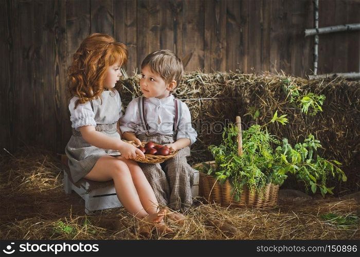 Children collect eggs for the Easter holiday.. A girl and a boy holding a dish with Easter eggs 6069.