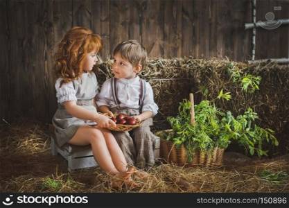 Children collect eggs for the Easter holiday.. A girl and a boy holding a dish with Easter eggs 6069.