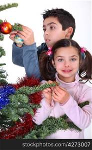 children decorating Christmas tree