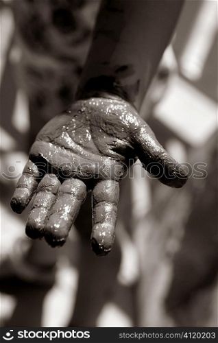 Children dirty black hands, paint game