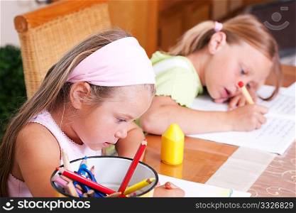 Children doing homework for school and preschool together